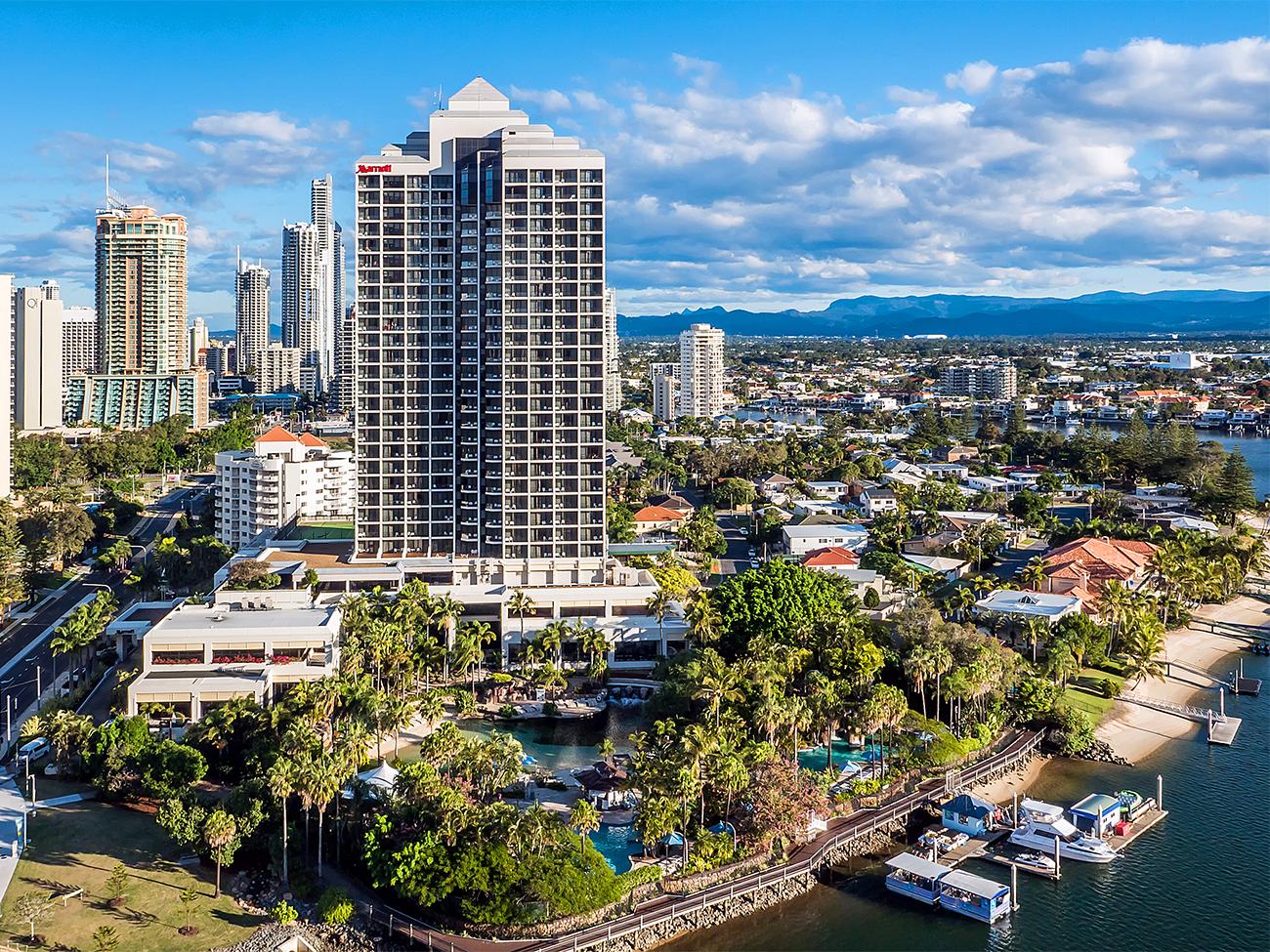 Aerial of exterior of Marriott Vacation Club at Surfers Paradise resort timeshare with waterway and boat docks in foreground